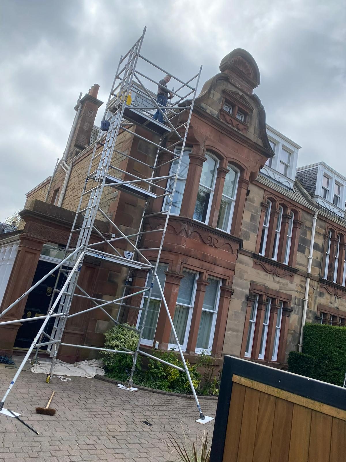 Access tower against a red sandstone villa
