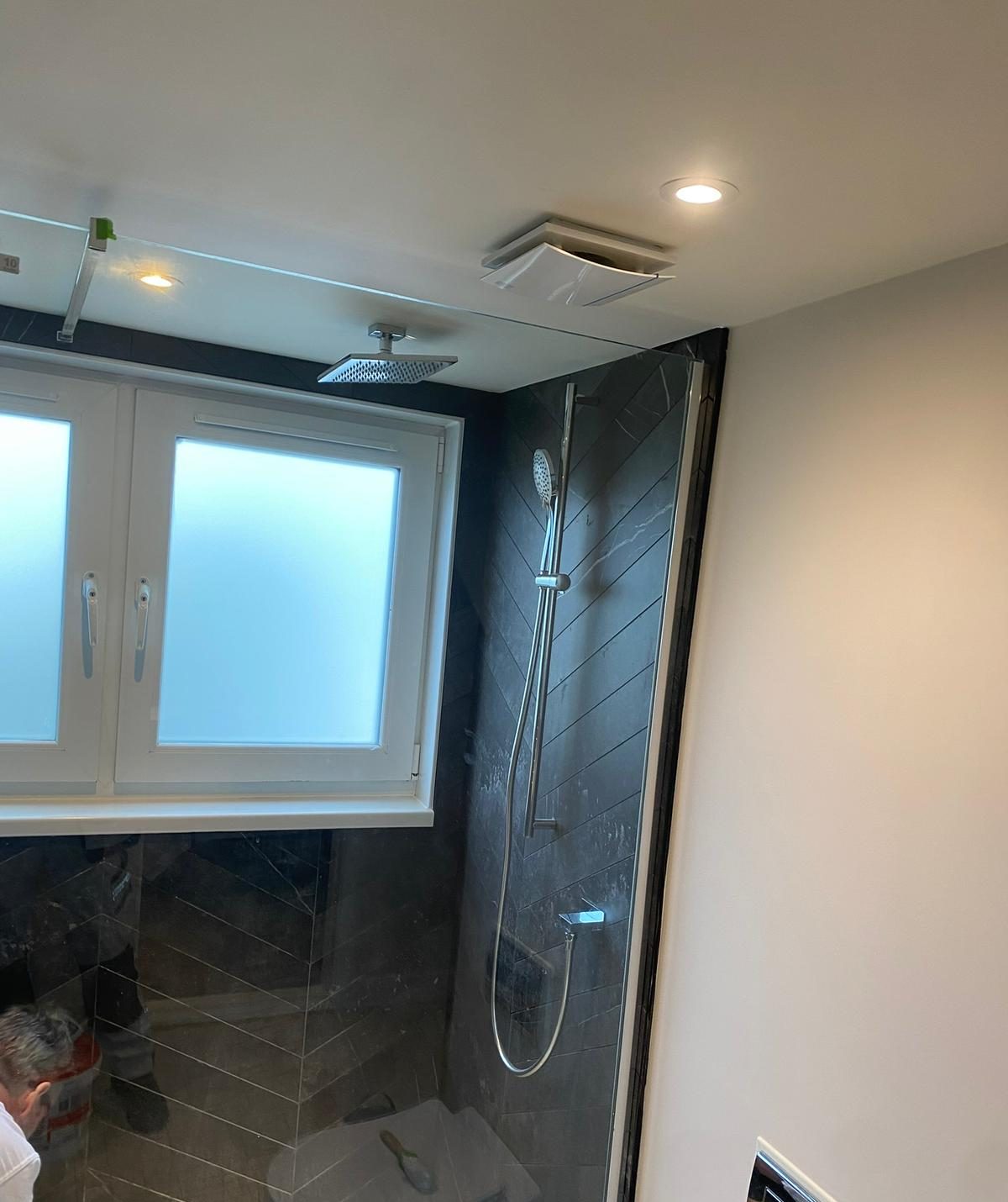 Walk-in shower with dark feature tiling