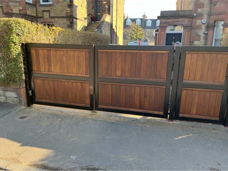 Refinished timber driveway gates in a black frame