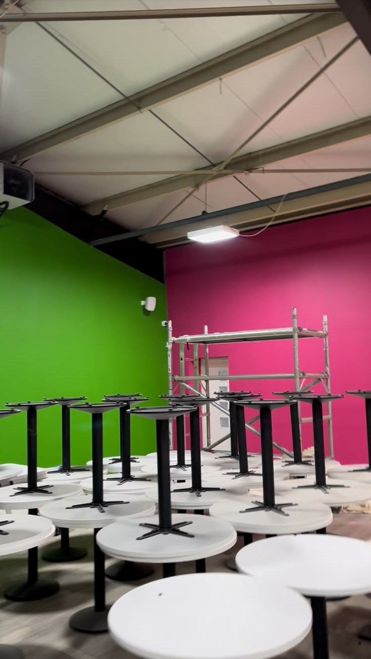 Green and pink feature walls painted from a scaffold tower