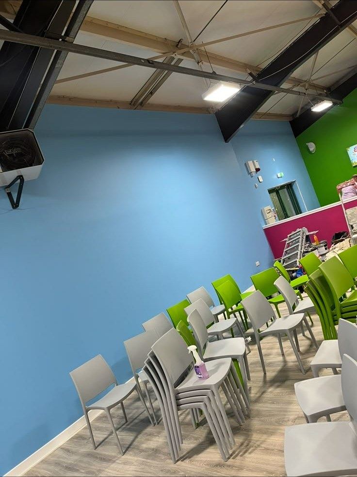 Blue and green painted seating area in a commercial unit