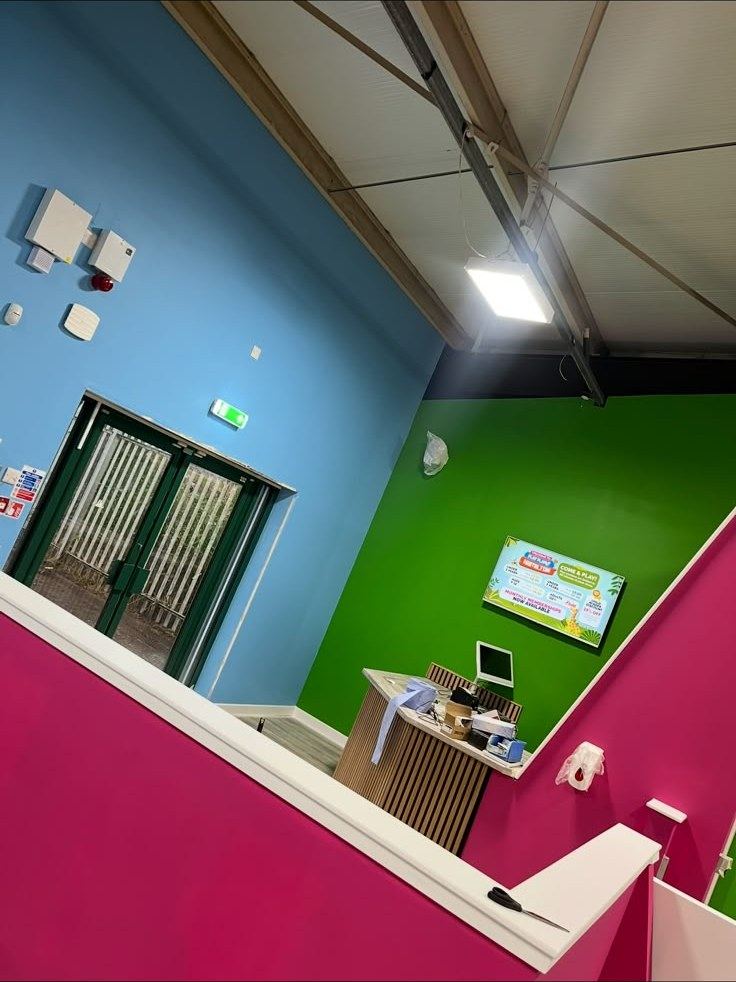 Reception area with blue, green and pink walls
