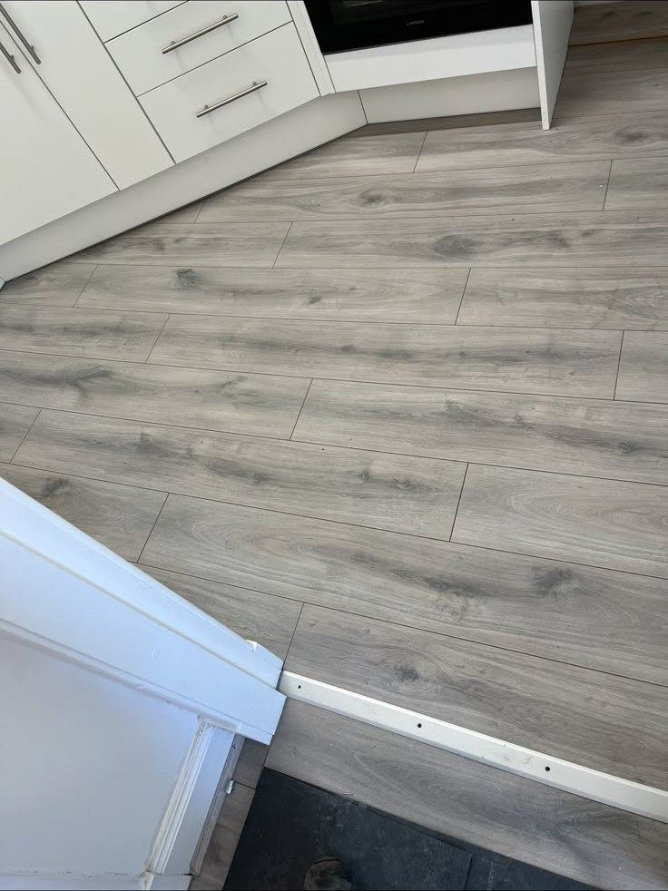 New grey laminate flooring fitted in a kitchen