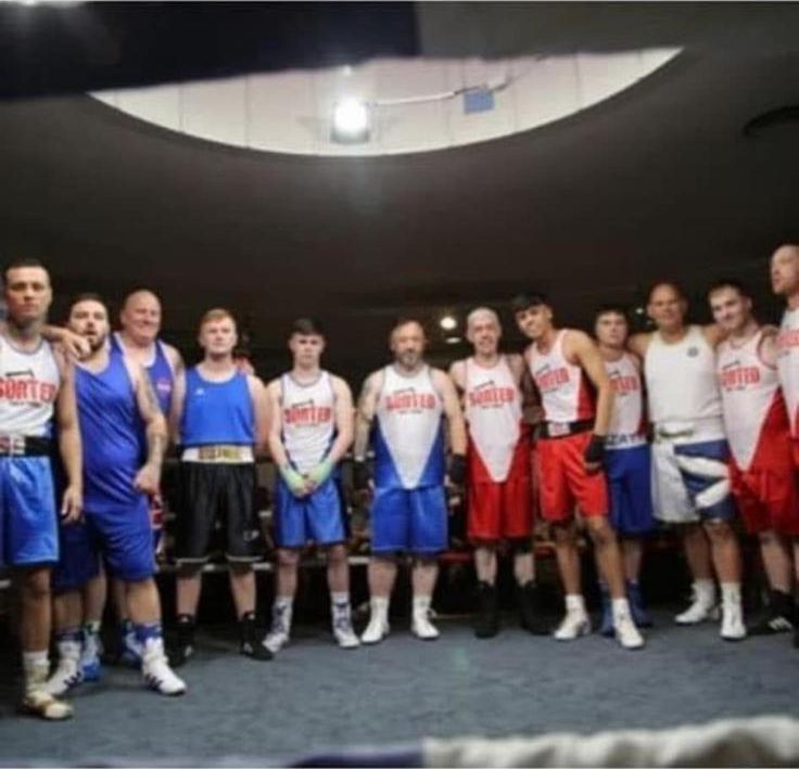 Boxing show line-up wearing SORTED sponsored vests in the ring